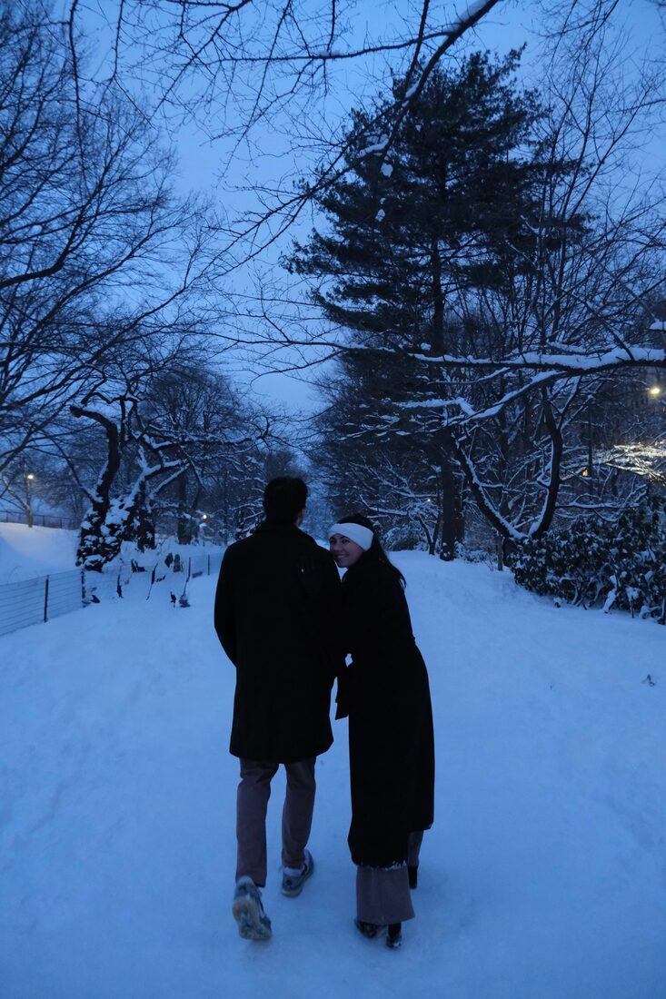 Katrina and Matthew walking together through a snowy park